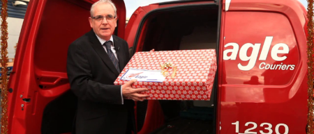 Jerry co-director of Eagle Couriers, a Courier Scotland company, putting present in van